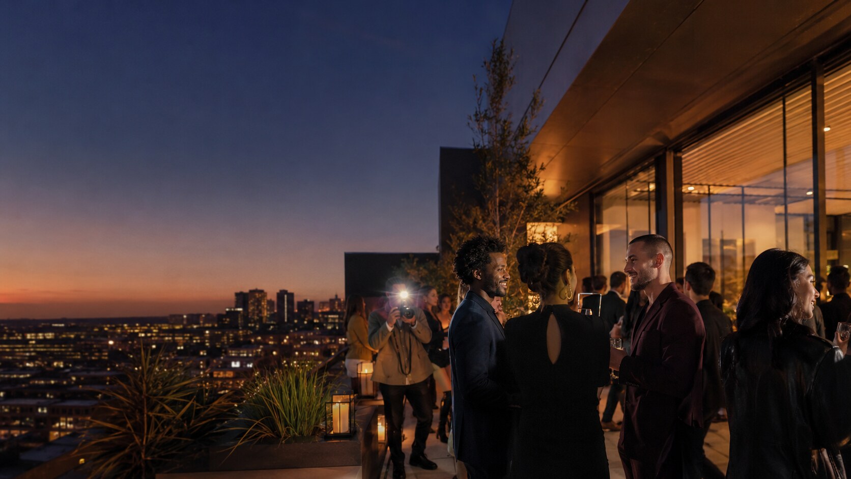 Guests and media at a sophisticated rooftop brand experience at dusk