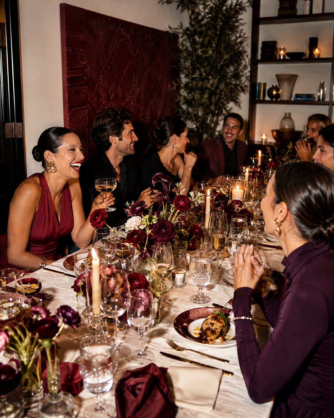 Guests gathered around a beautifully set table at an evening hospitality launch