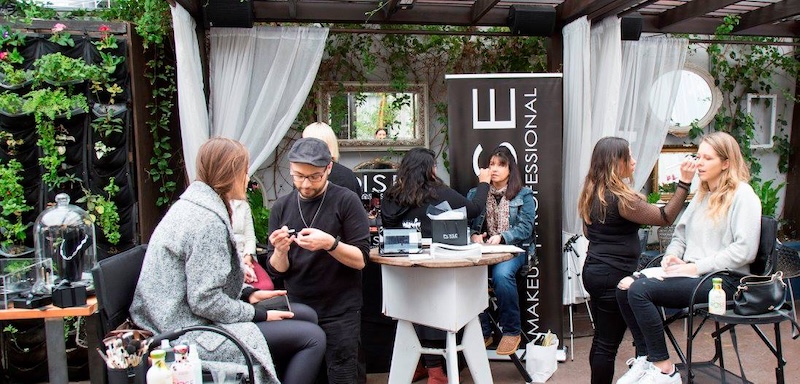 Guests enjoying an outdoor makeup brand activation
