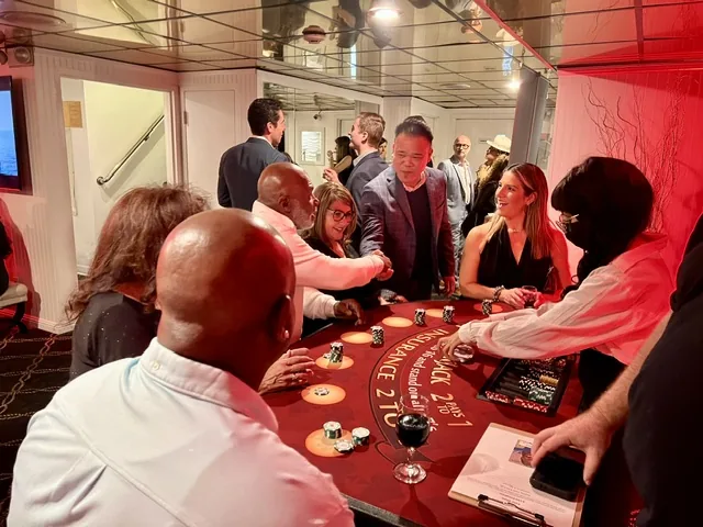 Guests gathered around a blackjack table at the Fantasea Football Casino Cruise